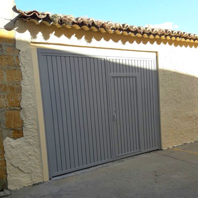 Puerta de garaje a medida en acero galvanizado con puerta peatonal,pintado de gris en Zamora